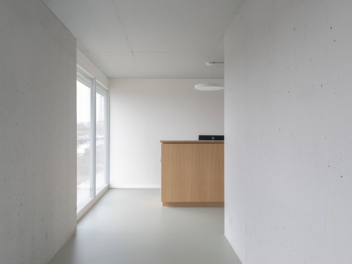 Modernité d’un intérieur épuré avec grandes fenêtres et réception bois.