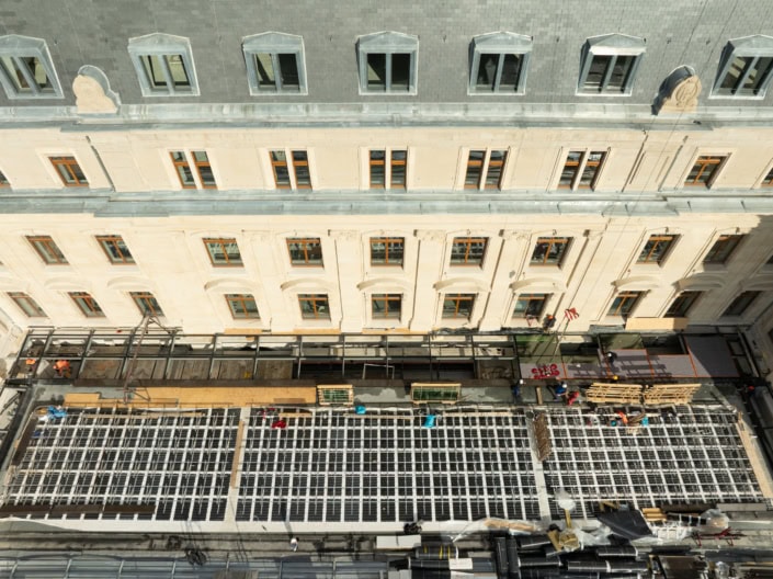 Ouvriers en construction sur un chantier en centre-ville à Lausanne, bâtiment rénové.